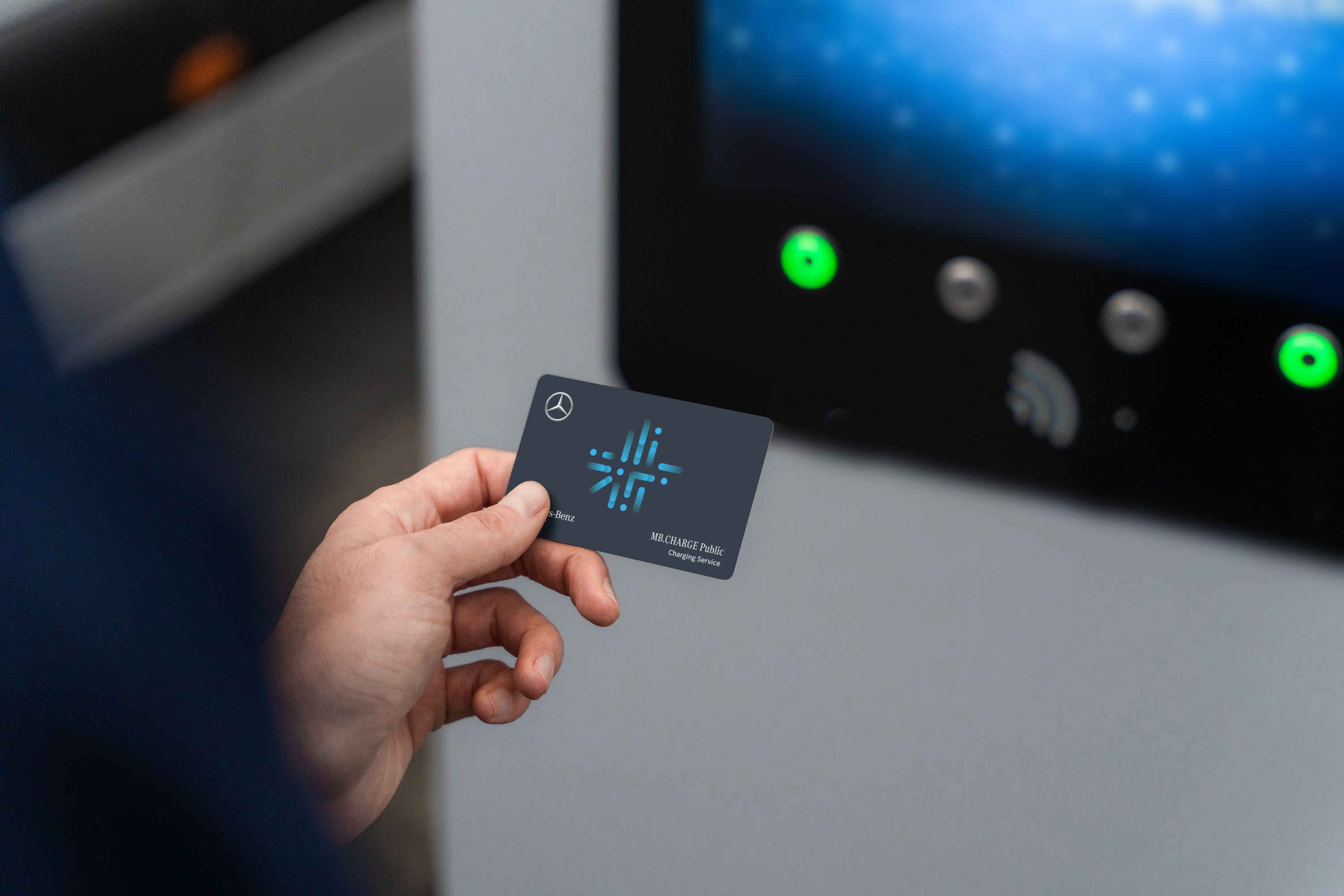 MB.CHARGE Public | Laddning | Mercedes-Benz Transportbilar Person håller laddkort för åtkomst till olika laddstationer.
