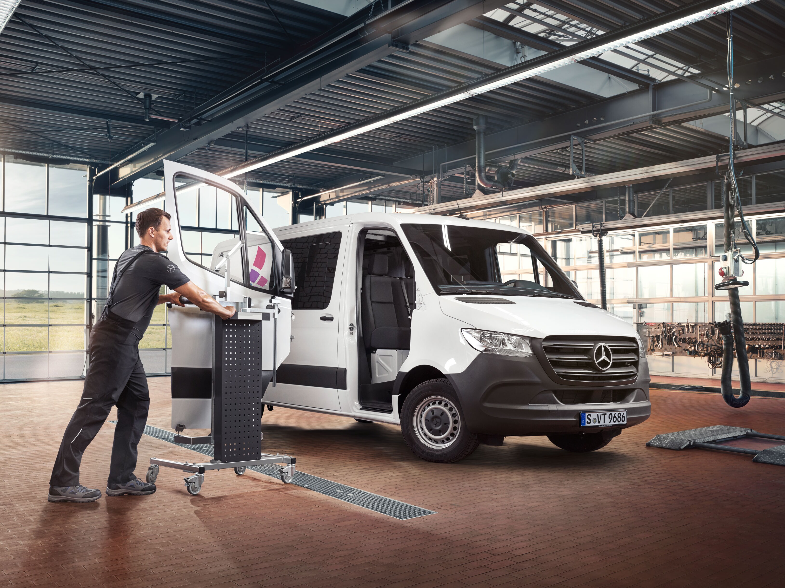 Mercedes-specialist använder specialverktyg på en transportbil.