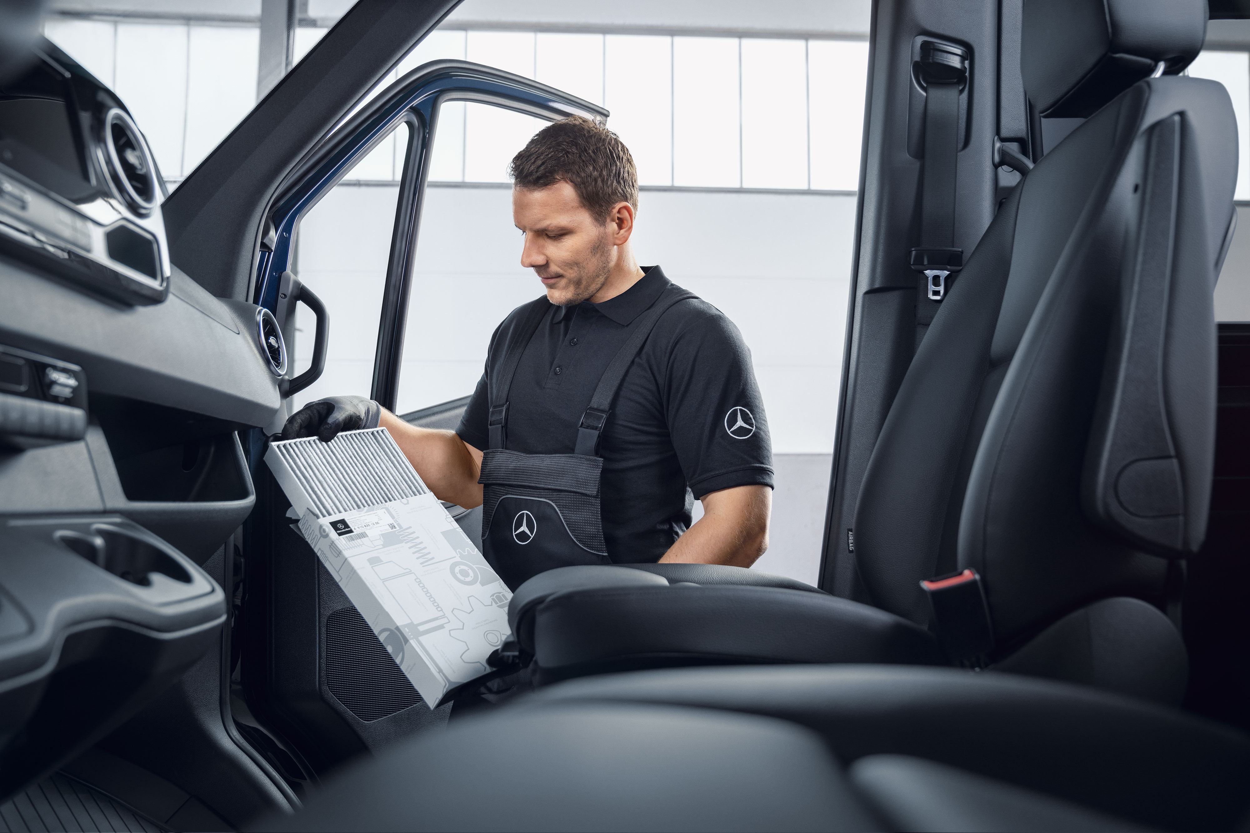 Mercedes-Benz | Service | Regelbunden service En Mercedes-Benz-mekaniker byter luftfilter.