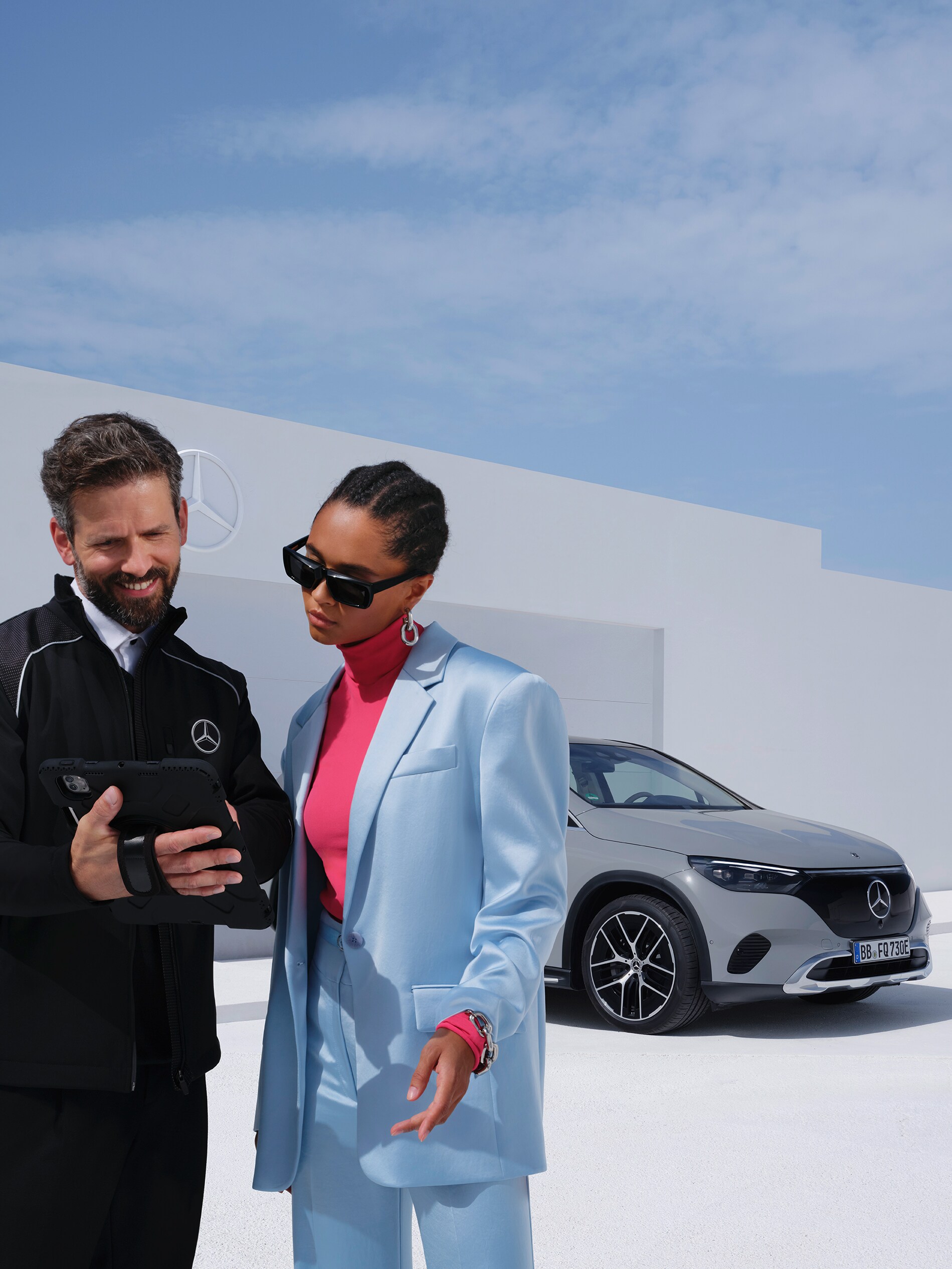 Kvinna pratar med en Mercedes-Benz-anställd om att leasa en elektrisk tjänstebil