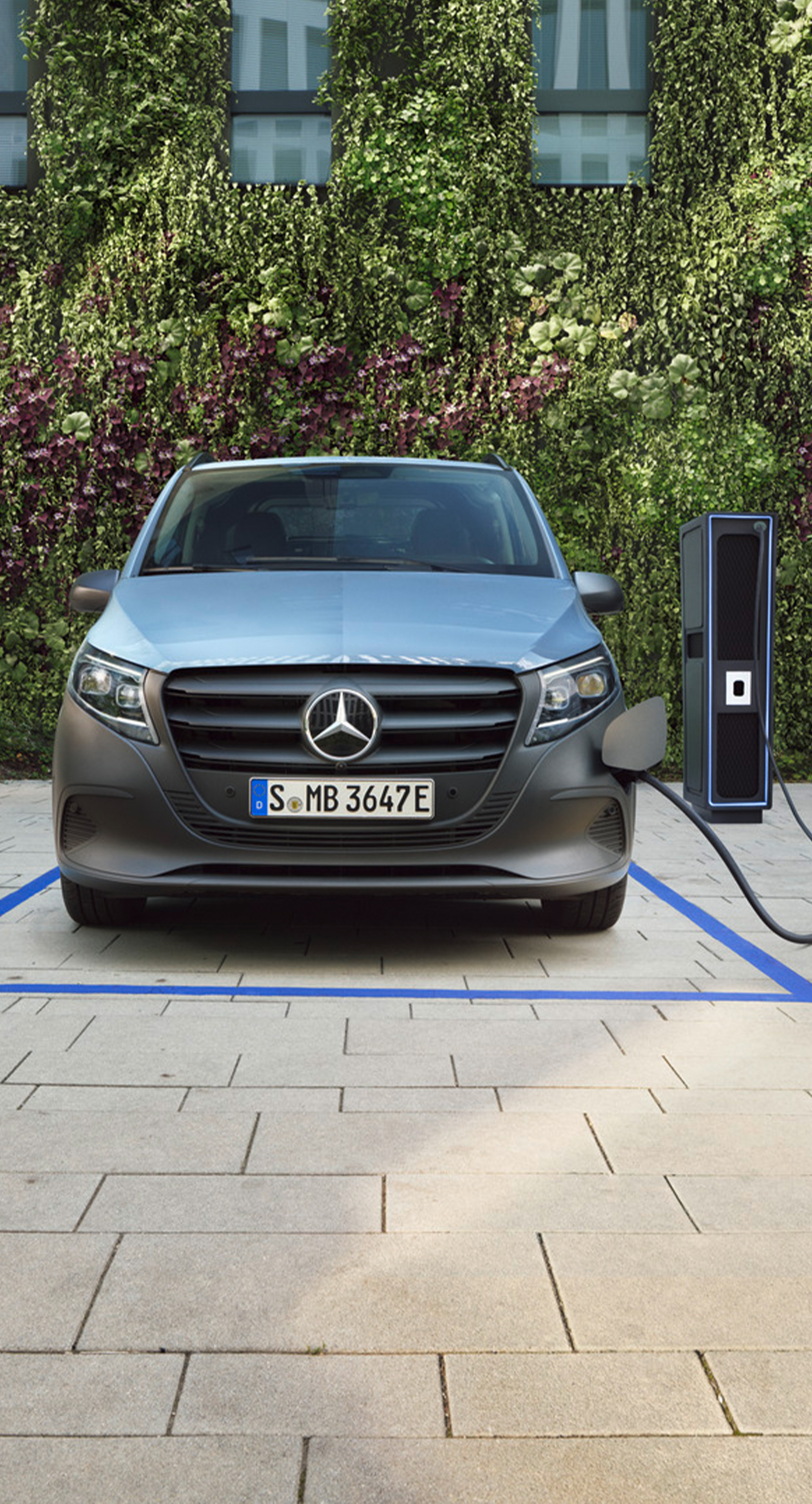 Metallicblå Mercedes-Benz eVito vid laddstation på parkeringsplats